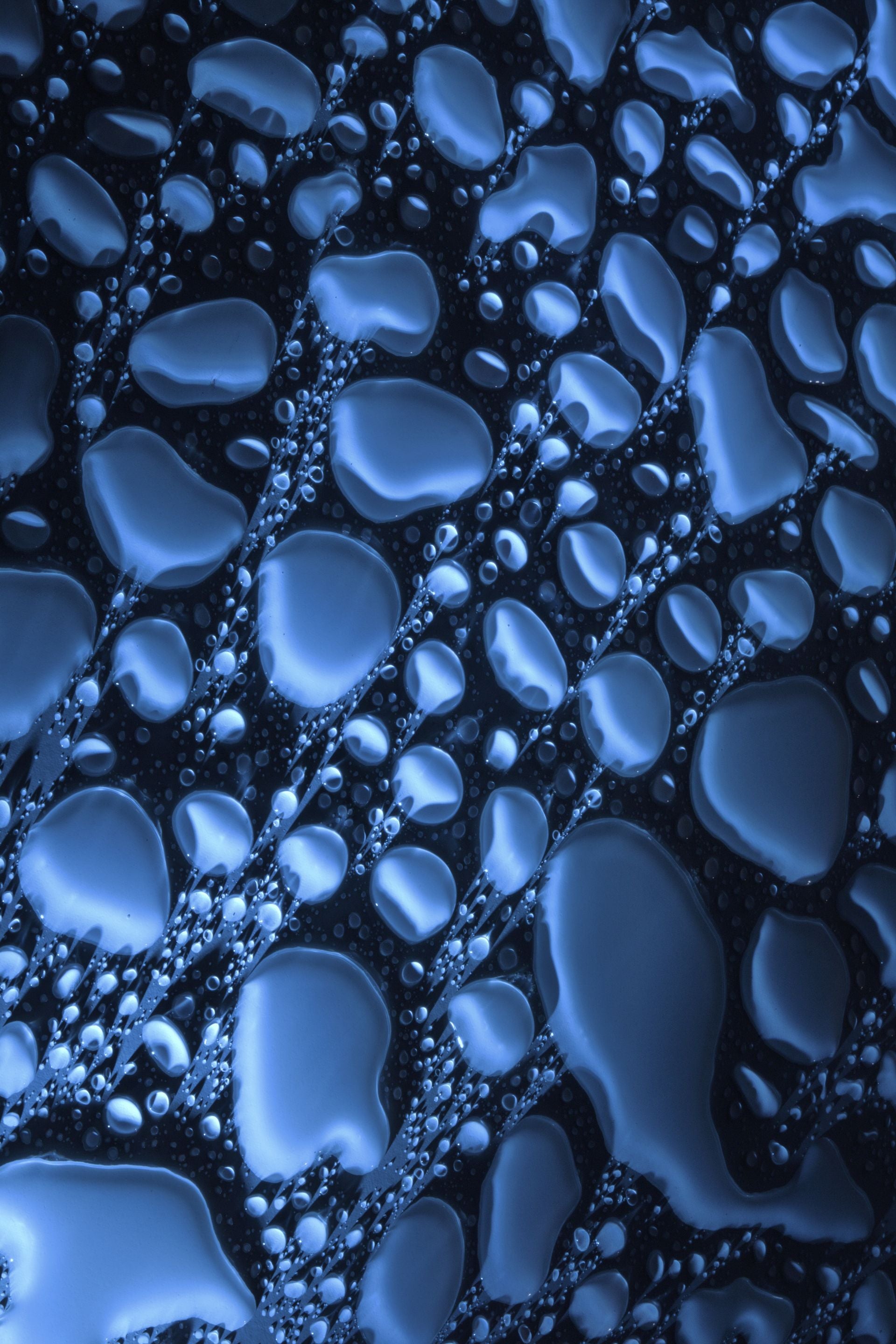Abstract blue water droplets on cold surface